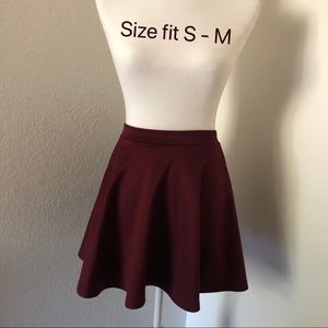 Deep red/purplish skirt.